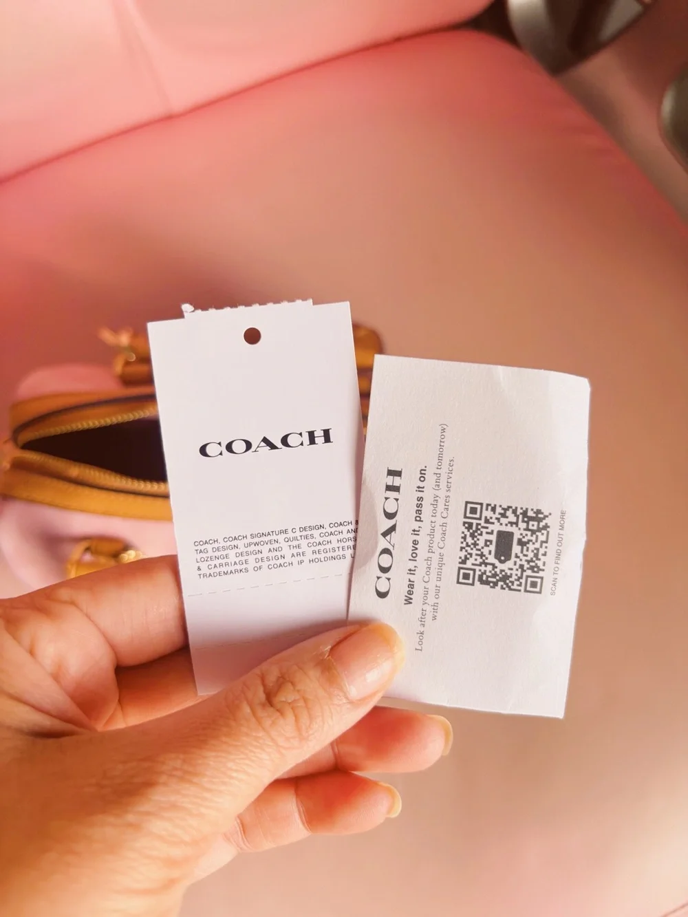 Coach mini rowan crossbody bag in signature canvas with charms.